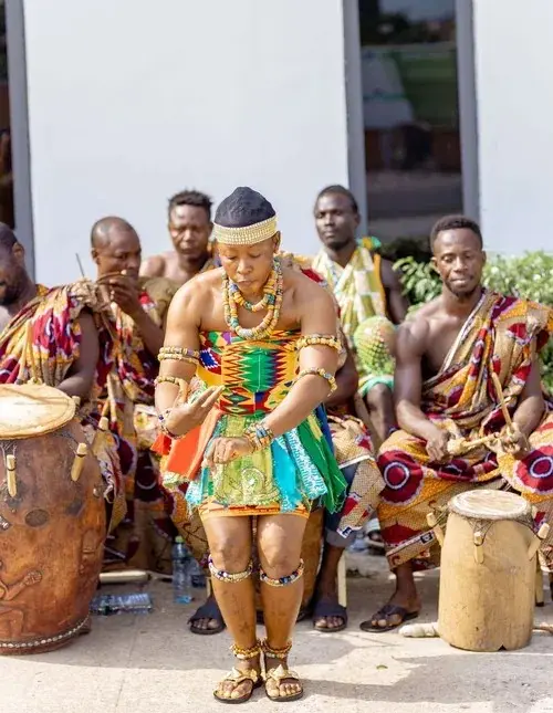A kente-clad dancer performing during a cultural celebration at ASA