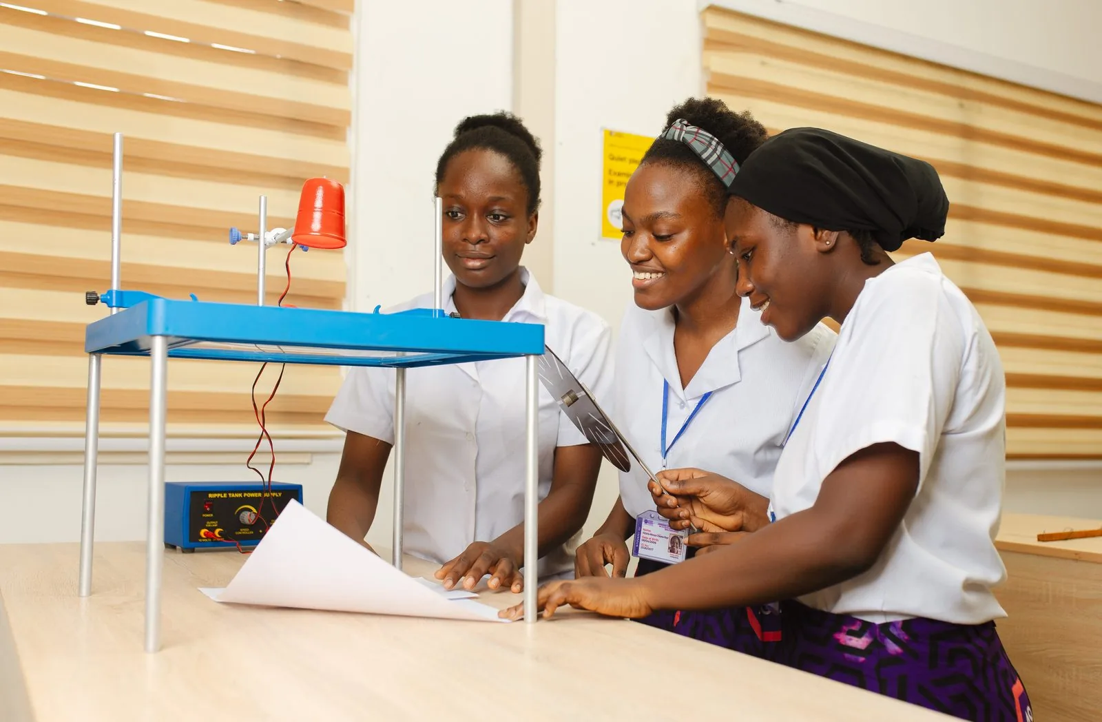 ASA students and teacher conducting a physics experiment
