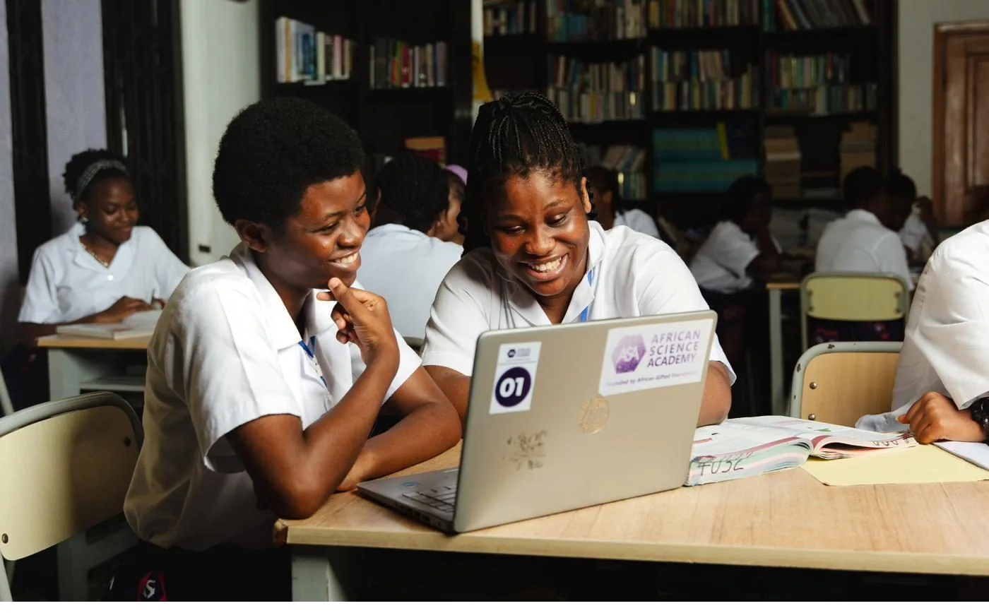 Two ASA students collaborating at a laptop in the school library