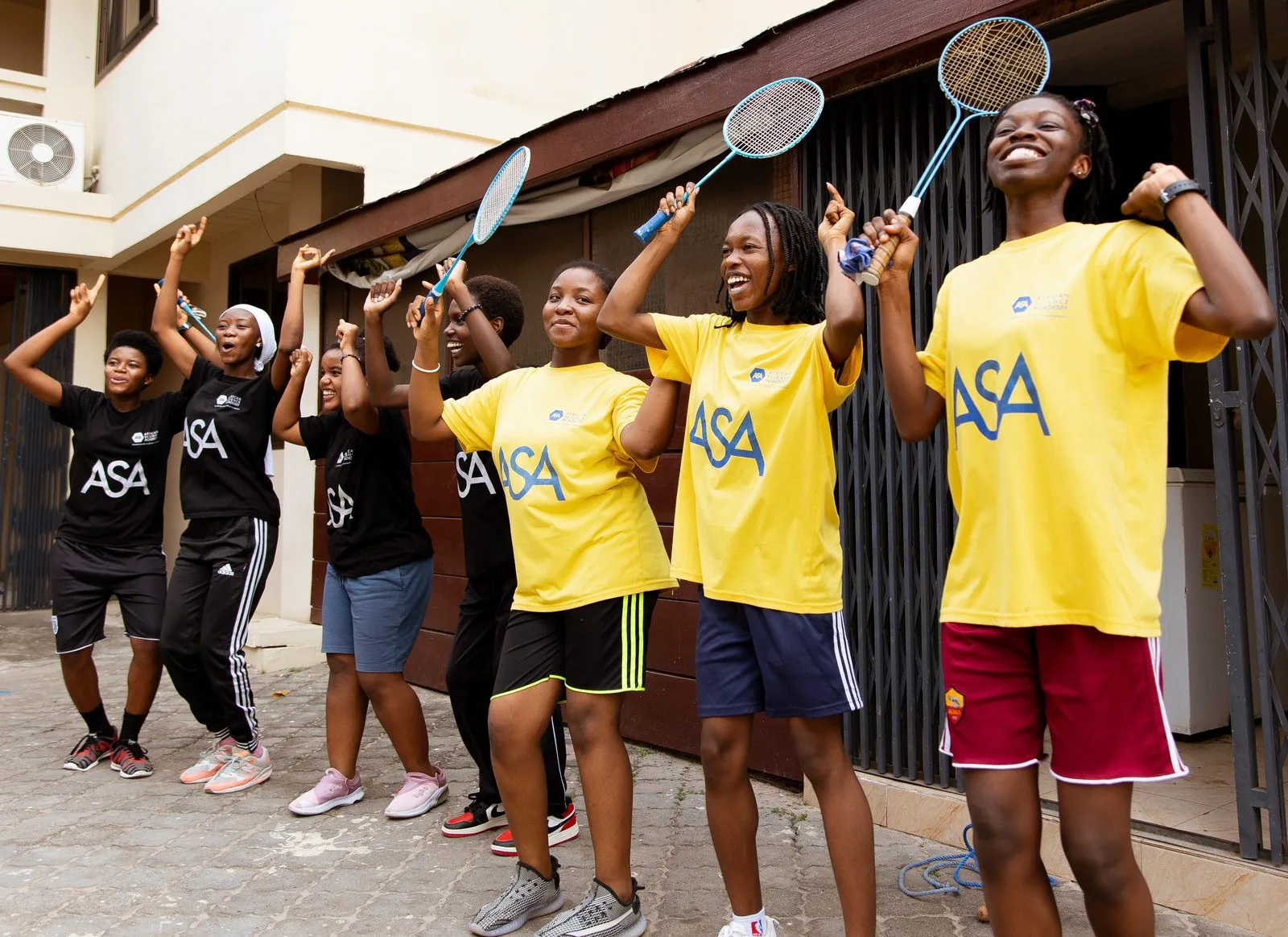 ASA students cheering with badminton rackets raised