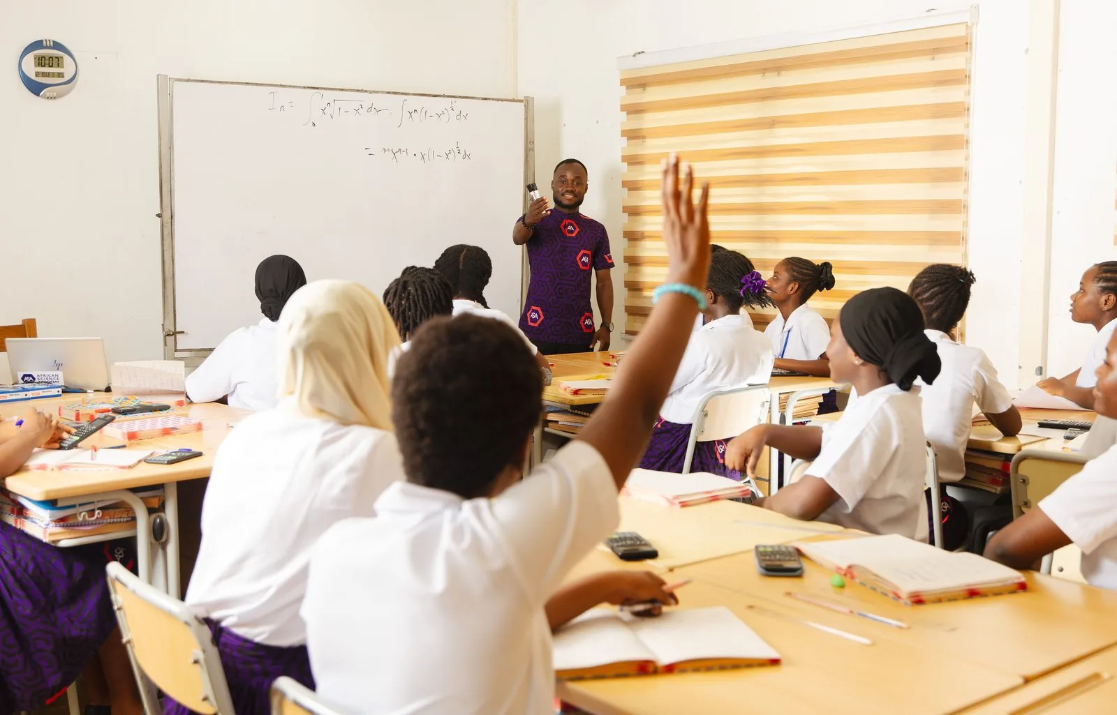 ASA students raising their hands to answer a question in class